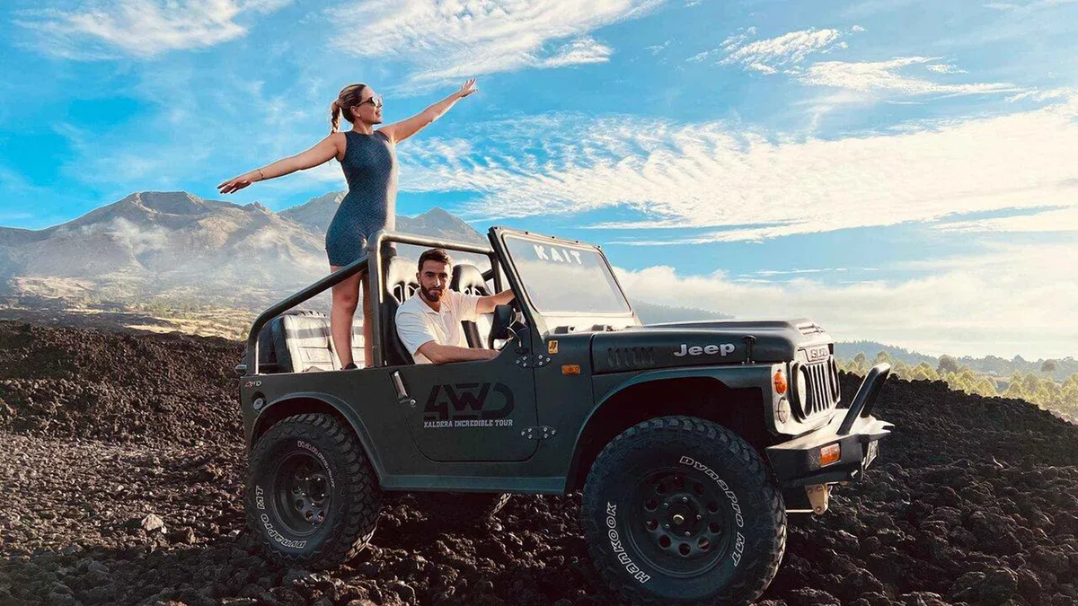 Open 4WD jeep parked on black lava at dawn on a Mount Batur sunrise jeep tour alternative to the hike, Kintamani, Bali
